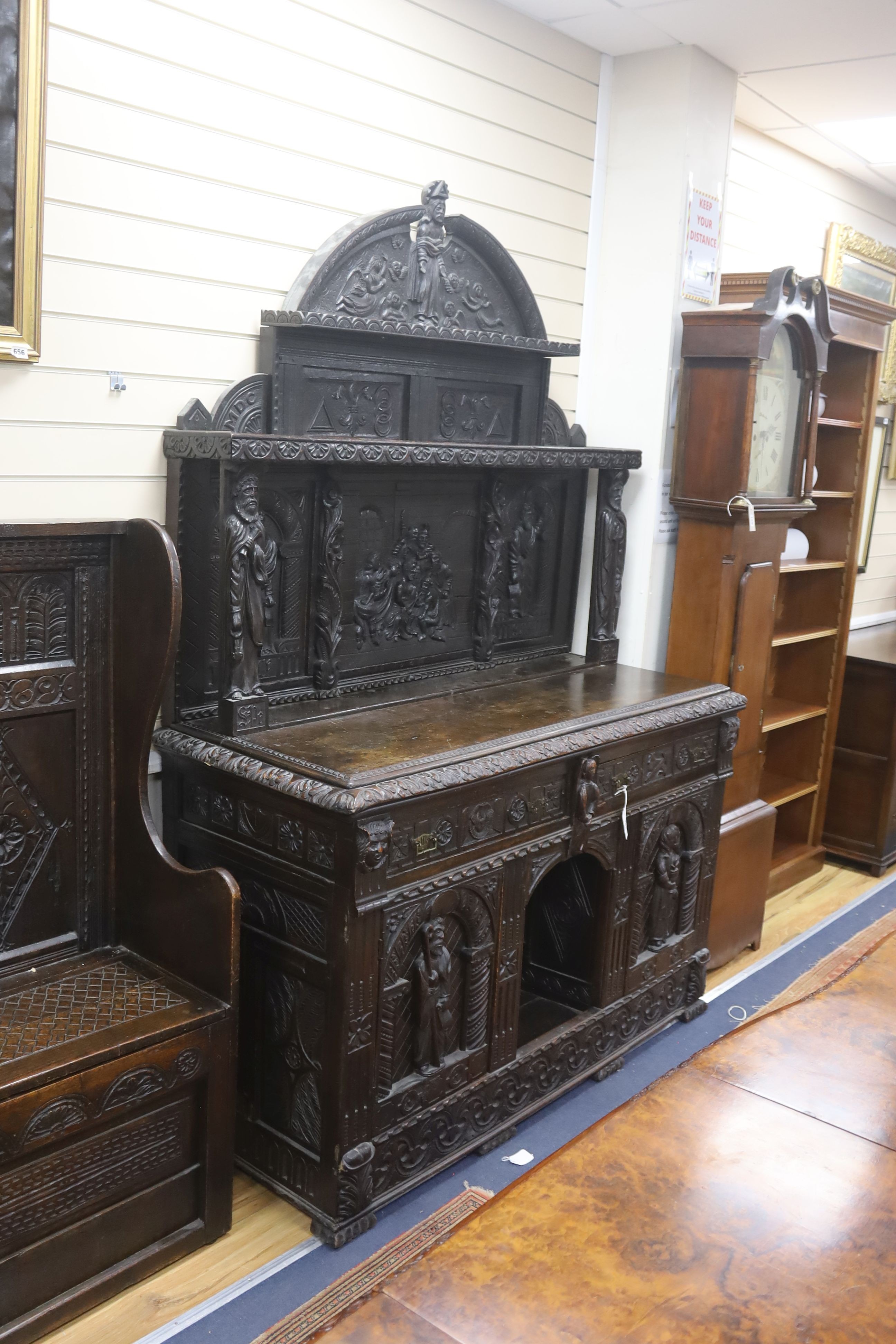 A late 19th century Flemish carved oak sideboard with raised panelled back, width 150, depth 60, height 215 cms.